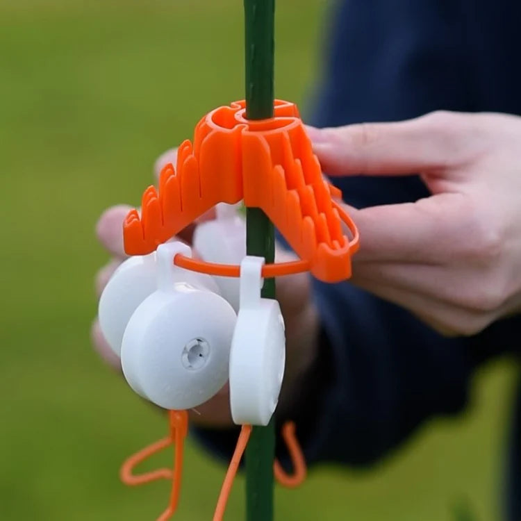 The Stringy-Thingy plant support clip attached to a grow frame in hydroponic setup